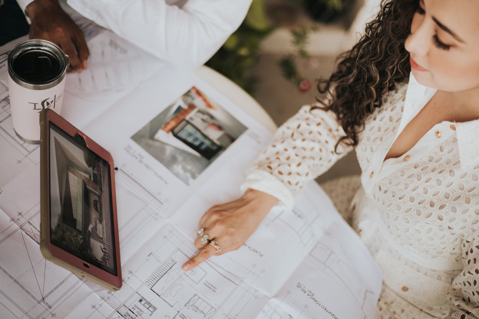 A business owner reviewing building plans and project details on a tablet