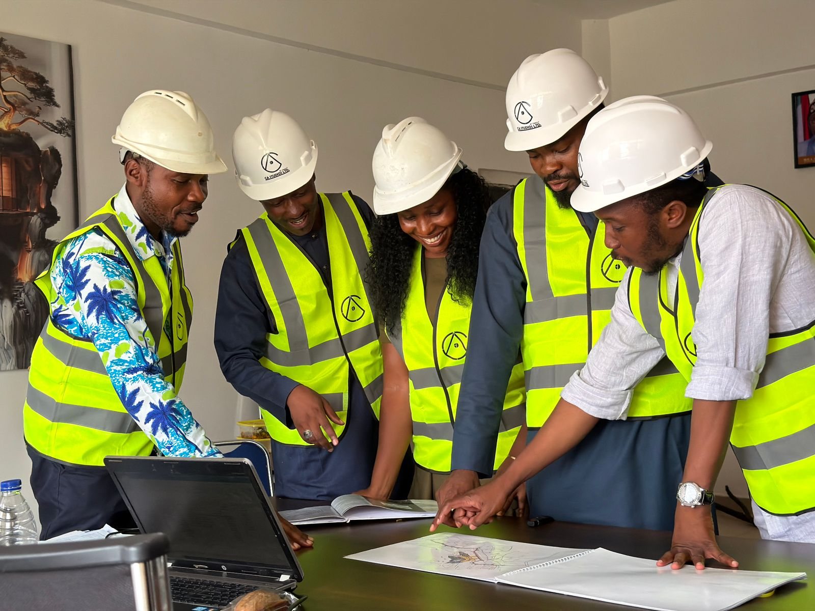 A mixed team of construction professionals reviewing project plans together