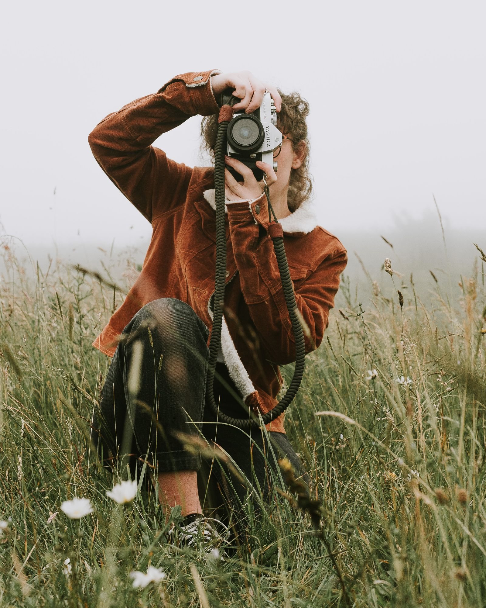 A professional photographer working outdoors with a camera