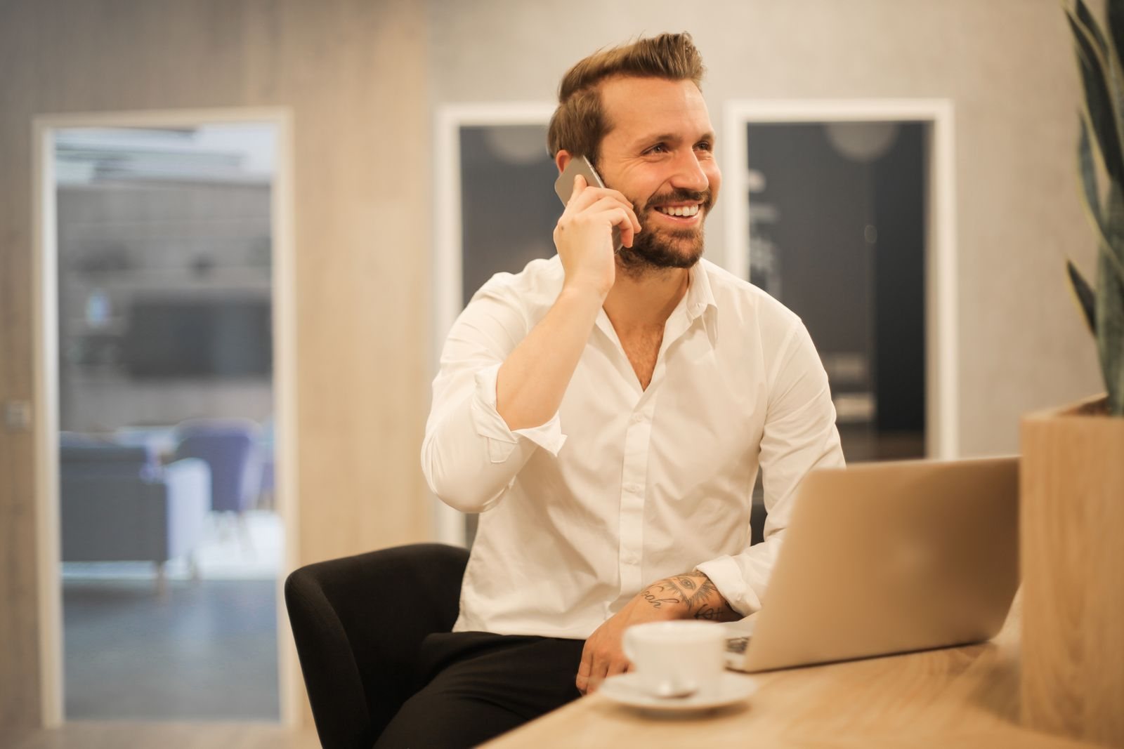 A business owner taking a phone call beside her laptop