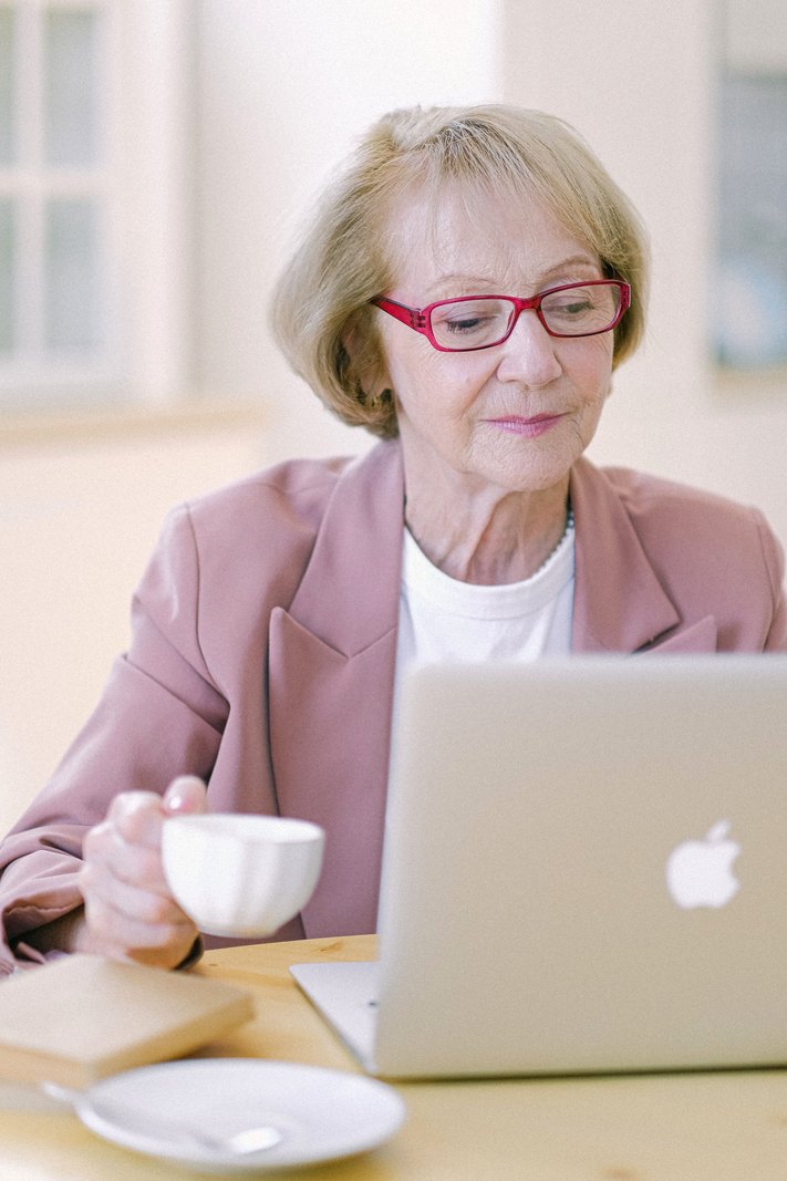 An experienced business owner managing scheduling from her laptop