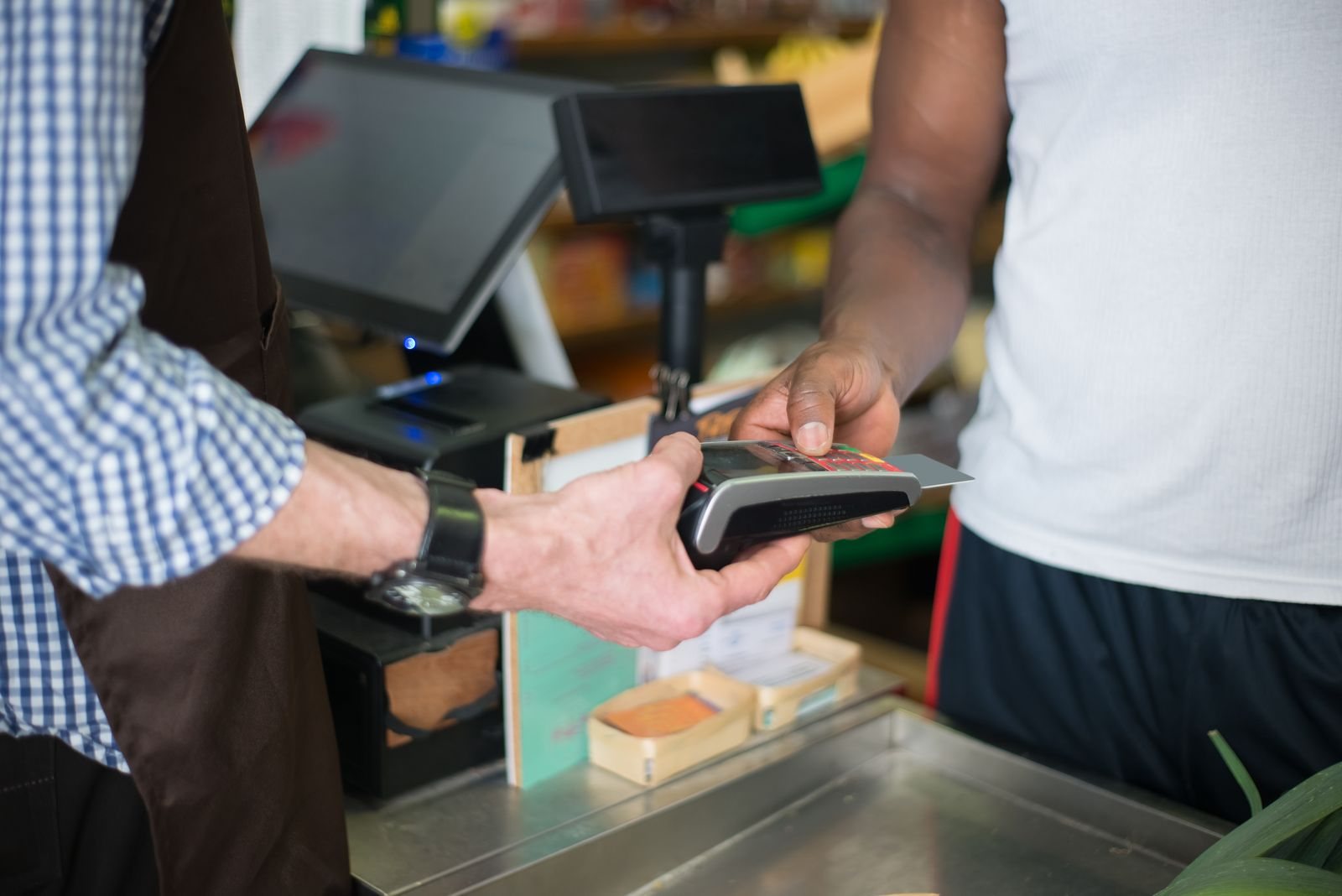 A customer making a card payment at a small-business counter