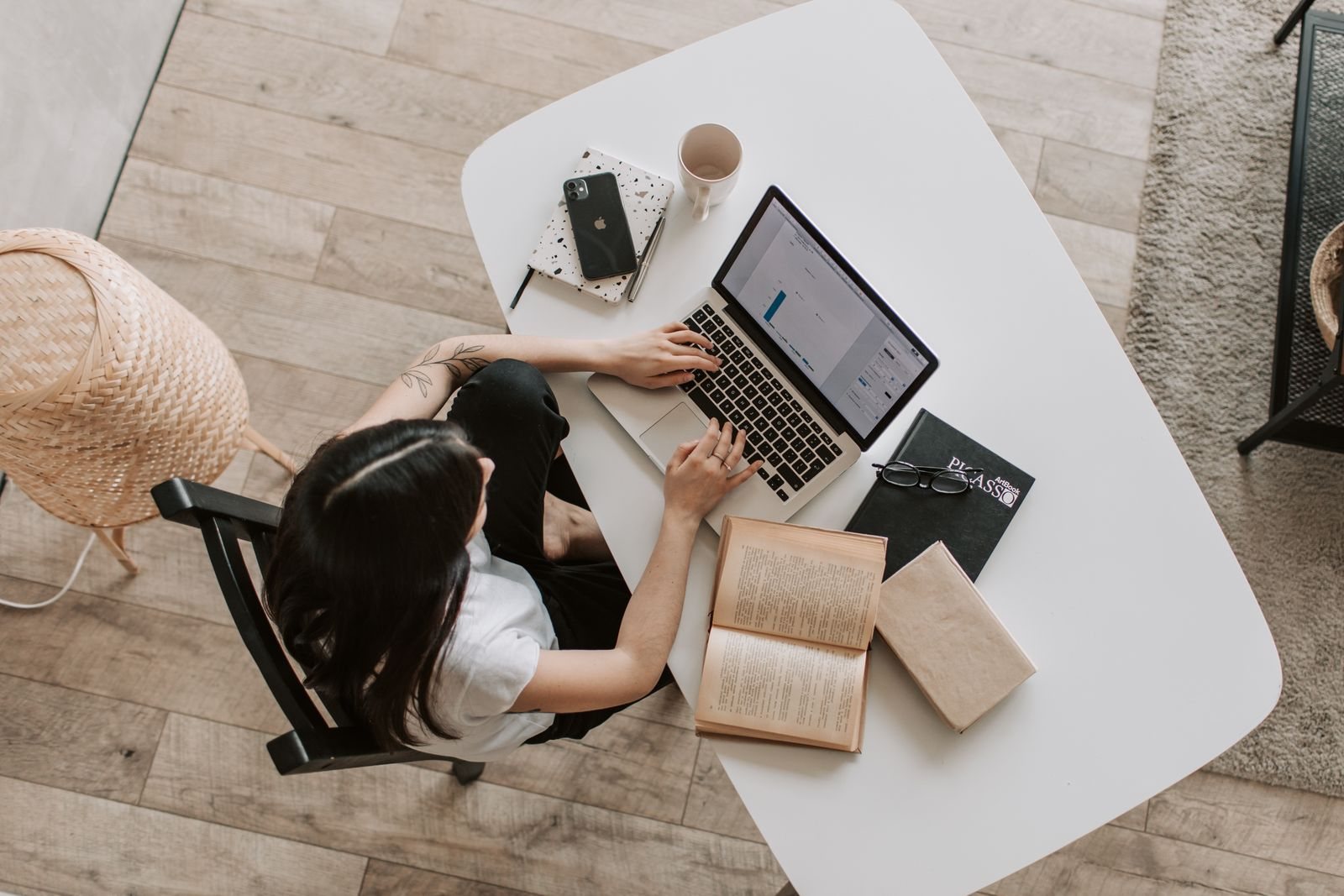 A business owner following up with customers from her laptop