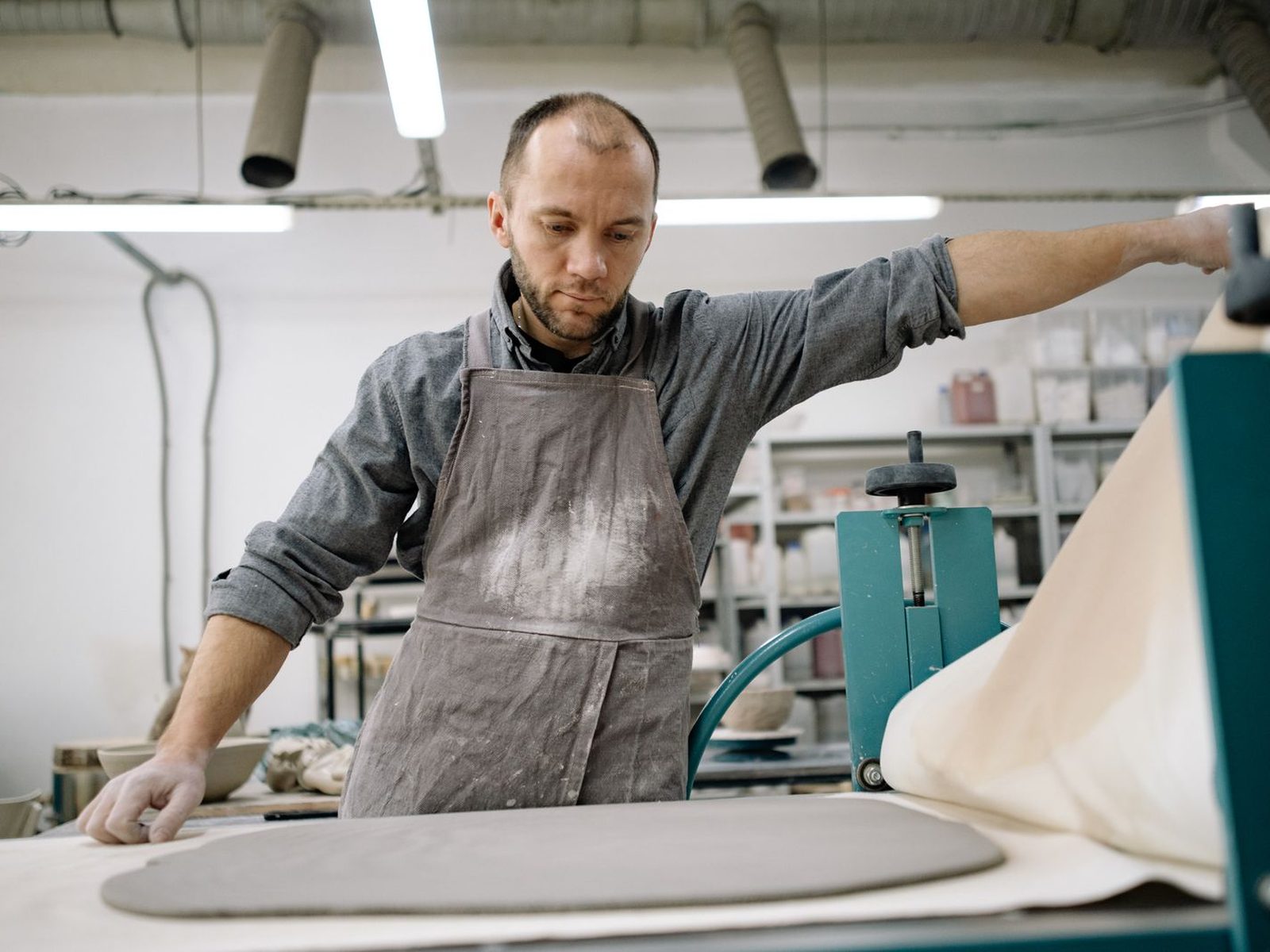 A ceramicist working alone in his studio
