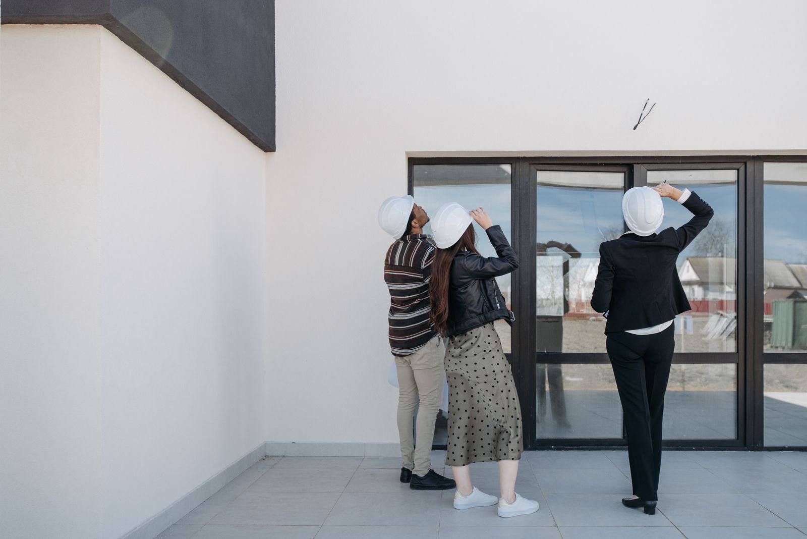 Three professionals inspecting a building together