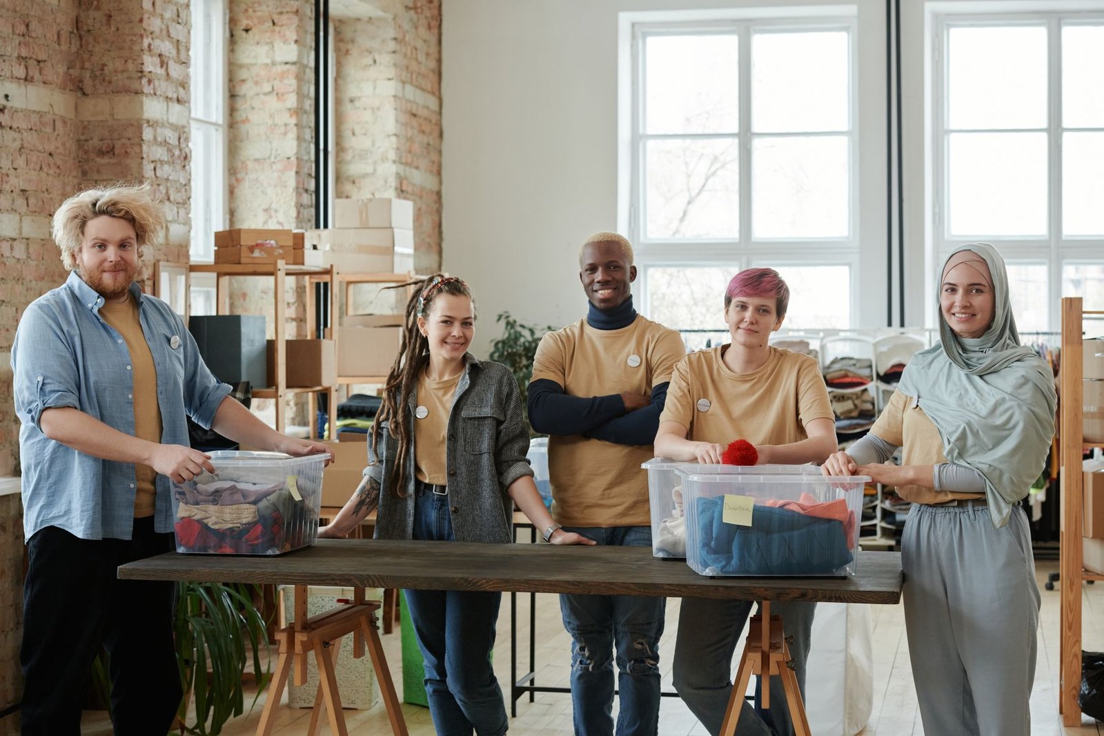 A diverse, mixed-age team of volunteers organizing donations together